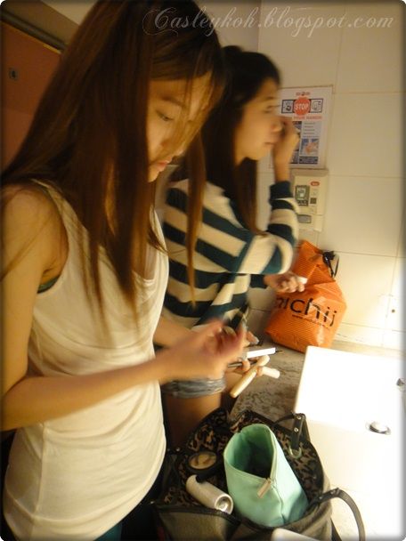 Fixing makeup in restroom